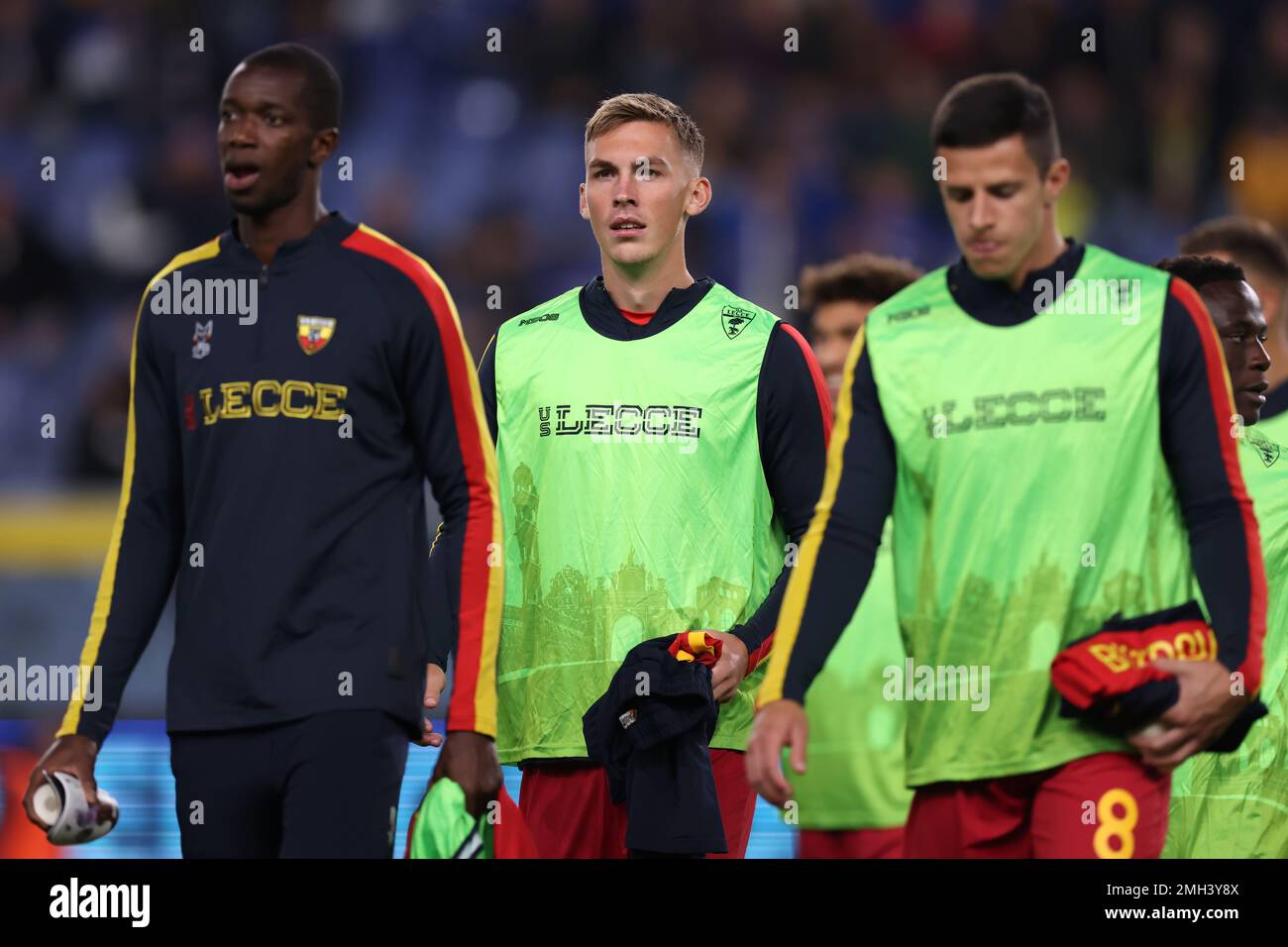 Genoa, Italy, 12th November 2022. Assan Ceesay, Kristoffer Askildsen and Kristin Bistrovic of US Lecce cross the field of play as they make their paths to the bench prior to kick off in the Serie A match at Luigi Ferraris, Genoa. Picture credit should read: Jonathan Moscrop / Sportimage Stock Photo