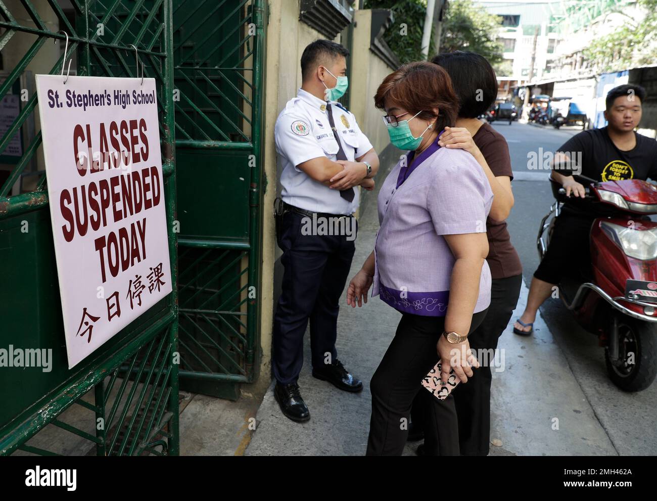 Teachers wear masks as they enter a ChineseFilipino school that