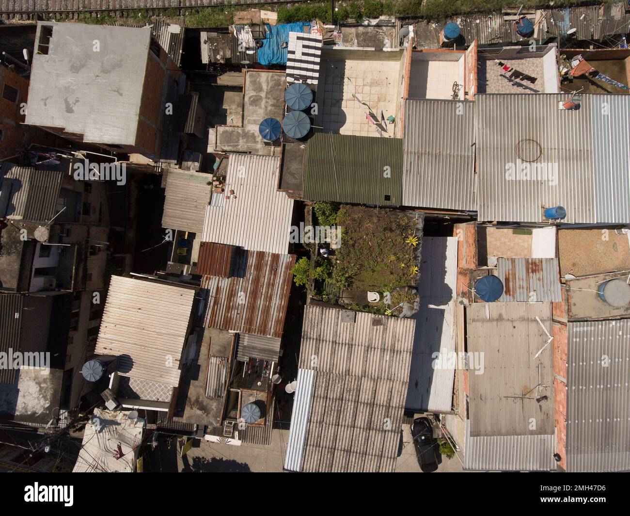 Favela Rooftops In this Jan.9, 2020 photo, Luis Cassiano sits in his green roof at his ...