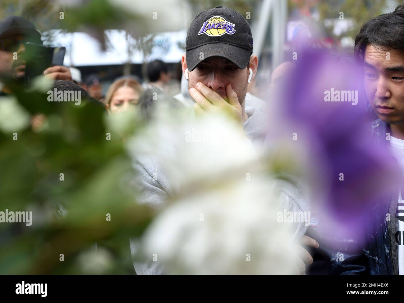 Lenard Gorokhov, of Calabasas, Calif., reacts at a makeshift memorial