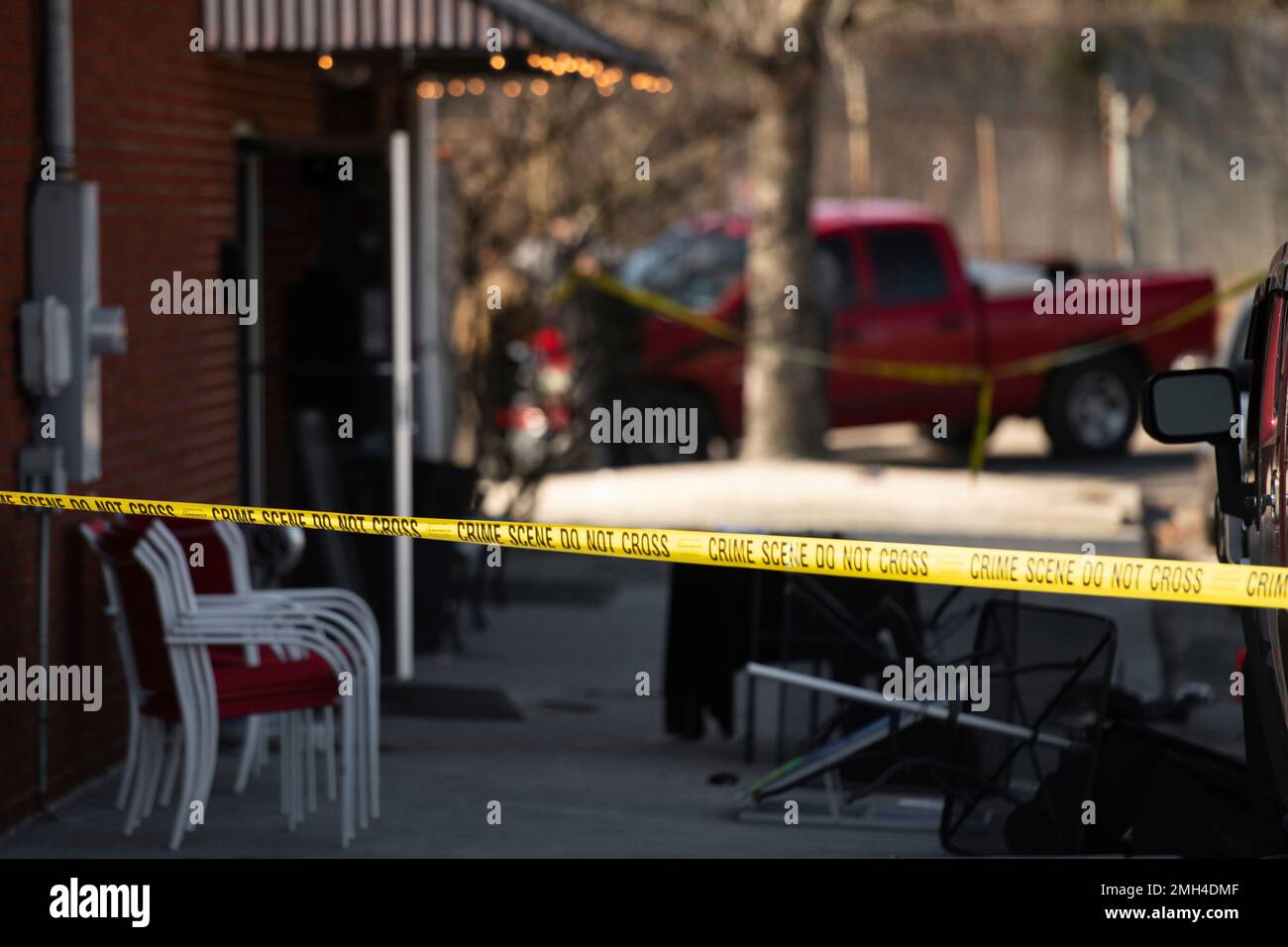 Crime scene tape stretches in front of Mac's Lounge, the scene of an