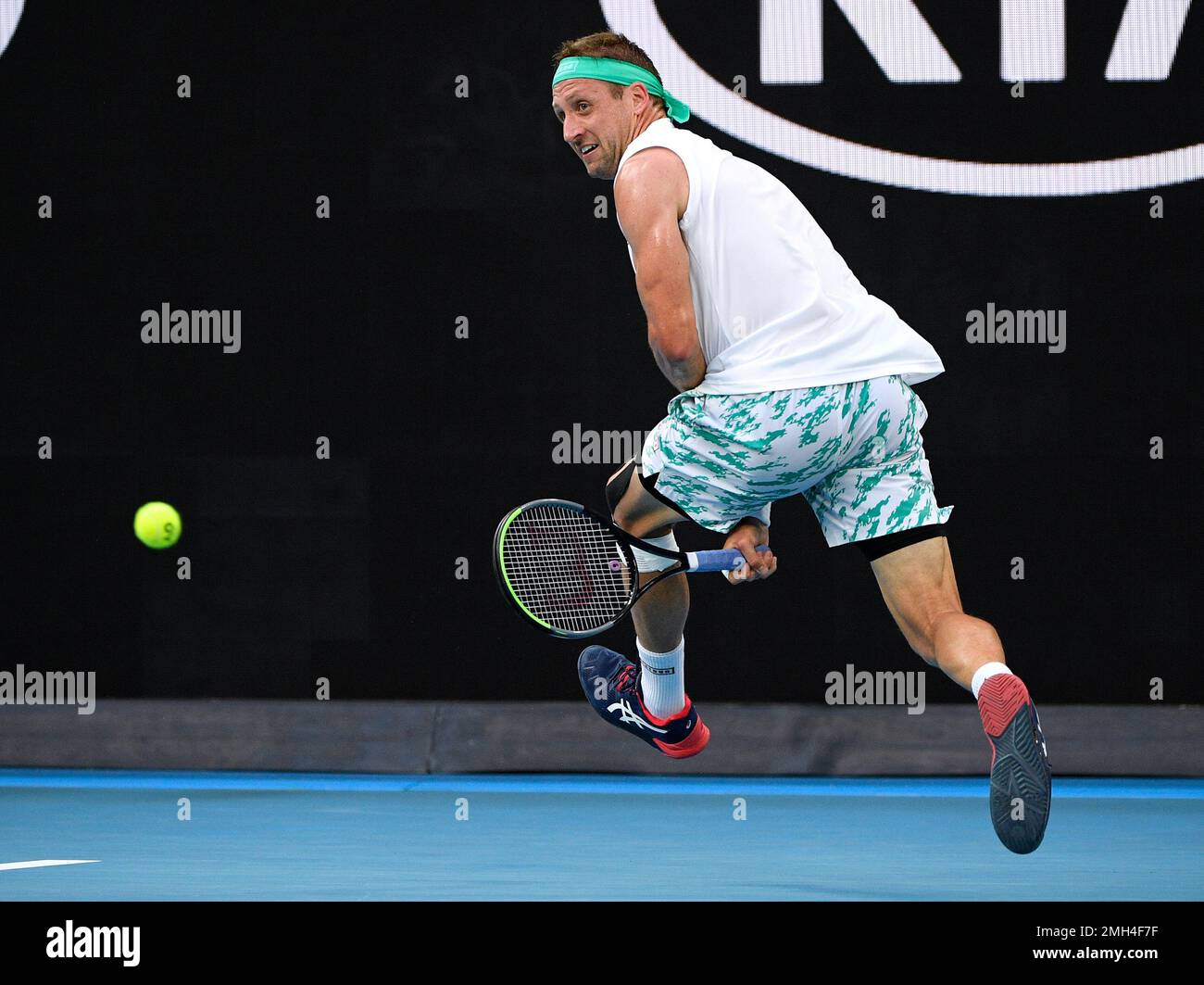 Tennys Sandgren of the U.S. plays a shot back between his legs to Italy's Fabio  Fognini during their fourth round singles match at the Australian Open  tennis championship in Melbourne, Australia, Sunday,