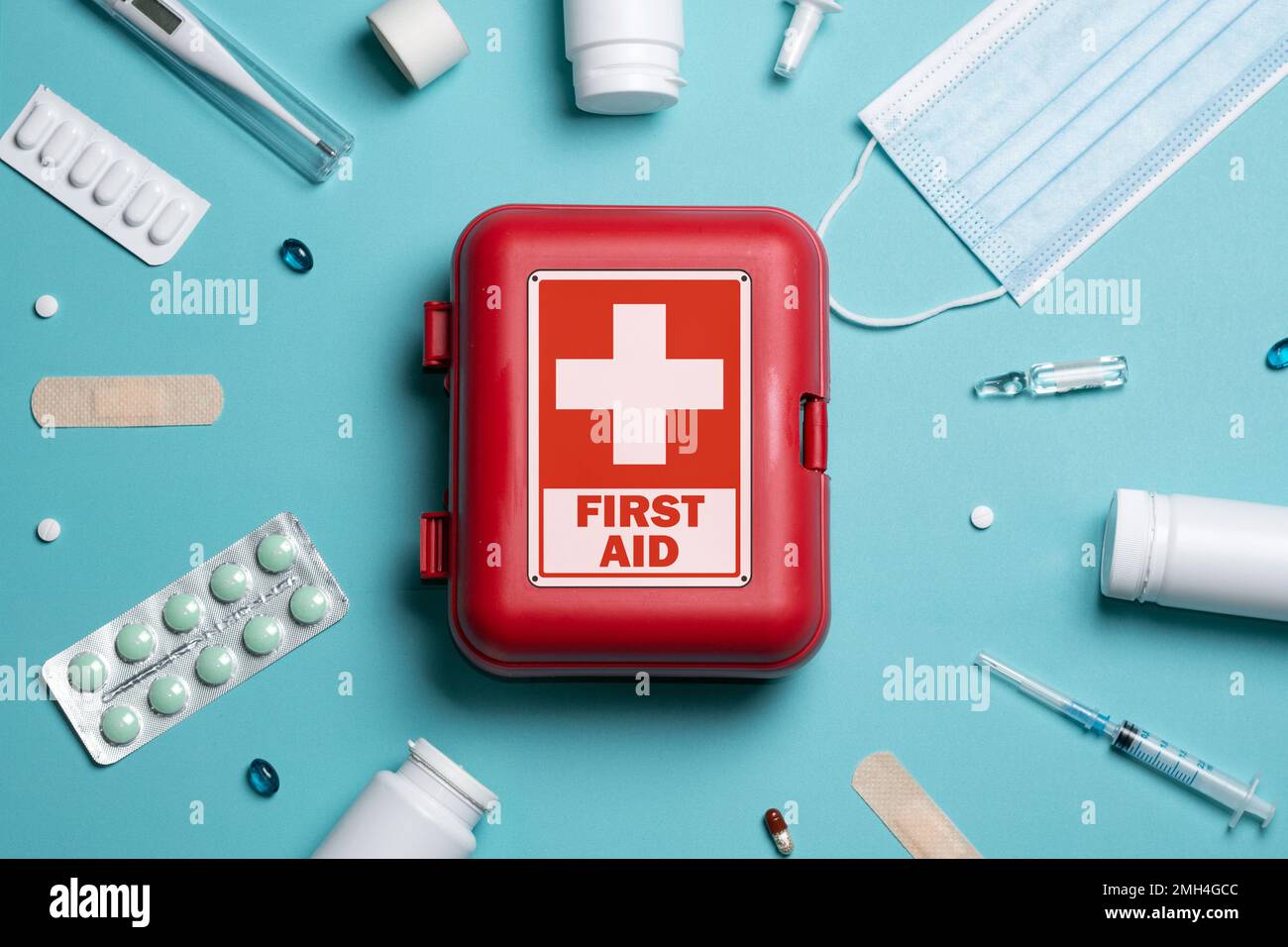 Home first aid kit on a blue background. The elements of the first aid