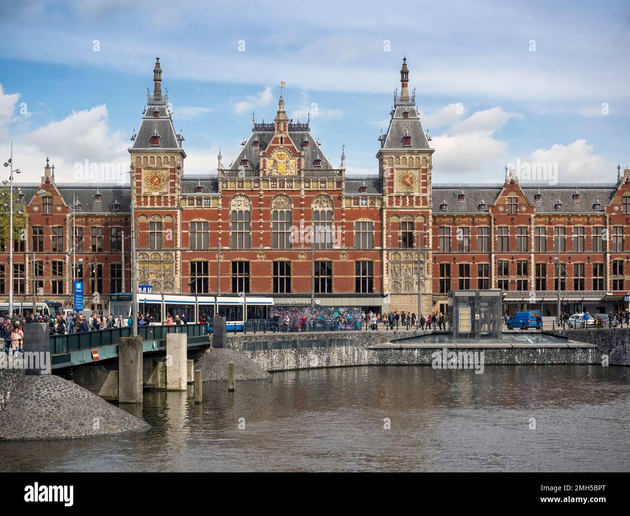 AMSTERDAM, NETHERLANDS - MAY 01, 2018:  Exterior view of Centraal Station seen across a canal Stock Photo