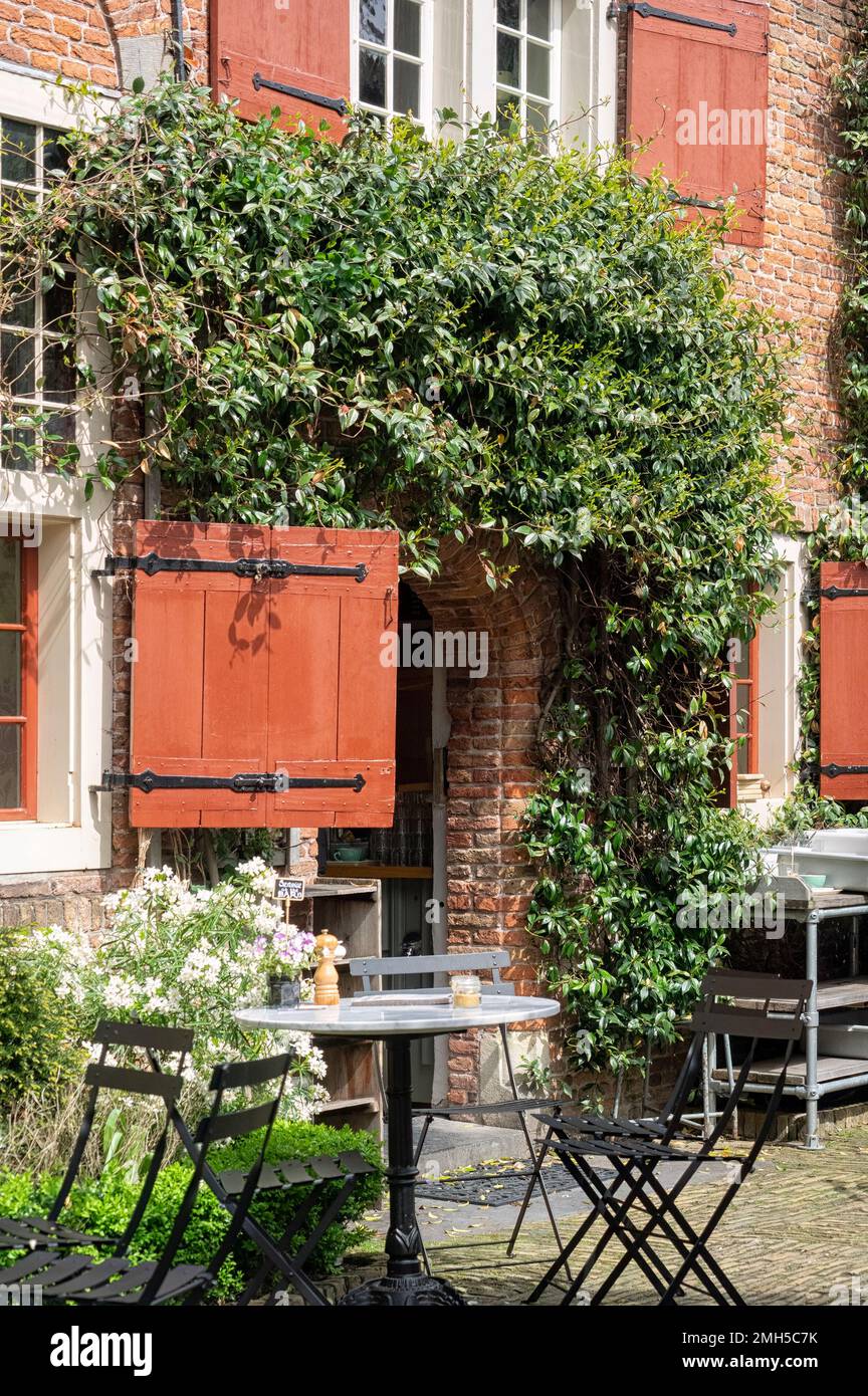AMSTERDAM, NETHERLANDS - MAY 01, 2018:  Pretty tables at the De Koffie schenkerij (Coffee and Cake) Cafe in the old sacristy of the Oude Kerk church Stock Photo