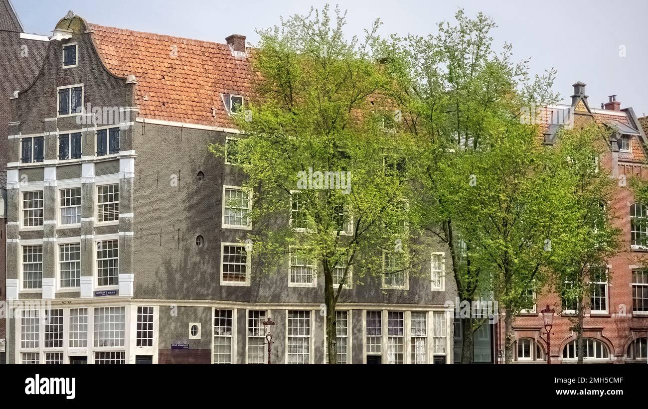 AMSTERDAM, NETHERLANDS - MAY 01, 2018:  Typical canalside house beside Geldersekade canal Stock Photo