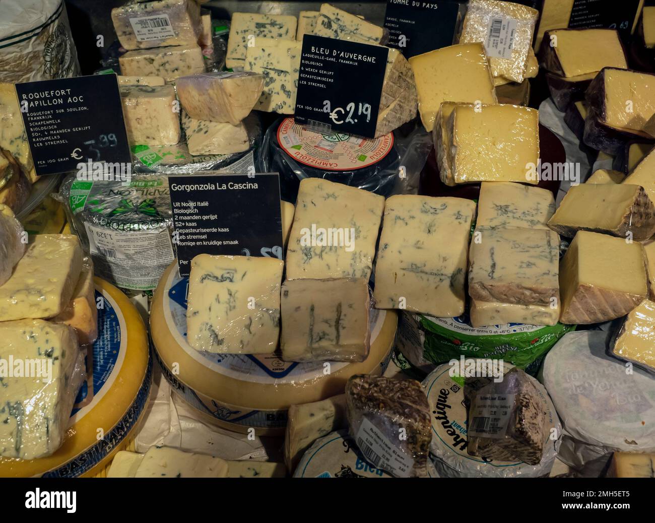 AMSTERDAM, NETHERLANDS - MAY 01, 2018:  Display of cheese in a cheese shop with price labels Stock Photo
