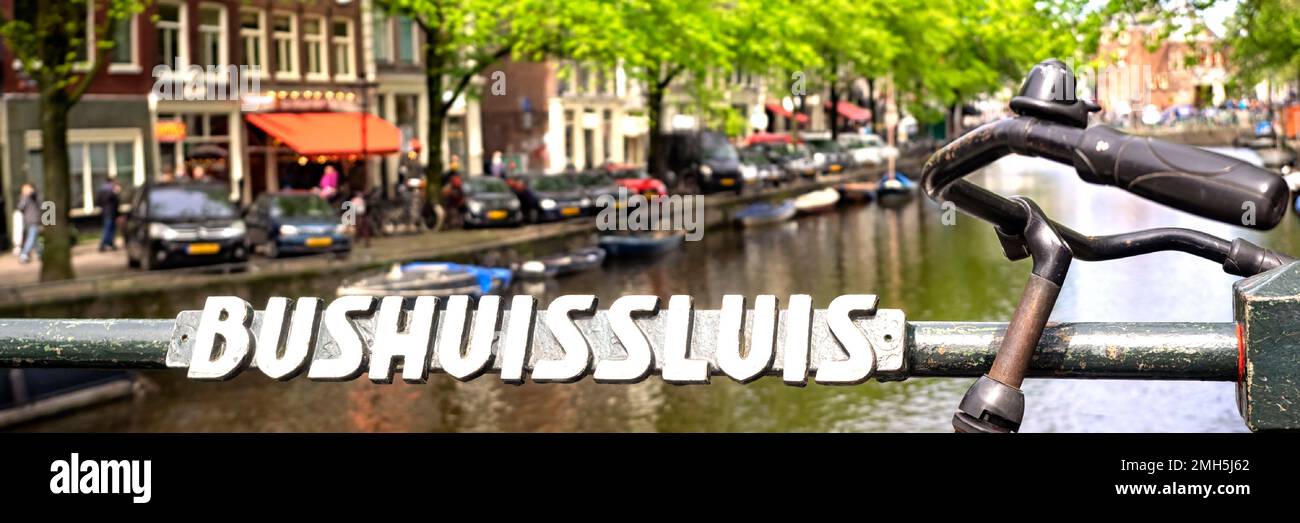 AMSTERDAM, NETHERLANDS - MAY 01, 2018:  Panorama view of sign on the The Bushuissluis bridge next to old vintage bike Stock Photo