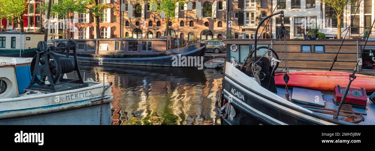 AMSTERDAM, NETHERLANDS - MAY 01, 2018:  Panorama view of boats and houseboats on the Brouwersgracht canal Stock Photo