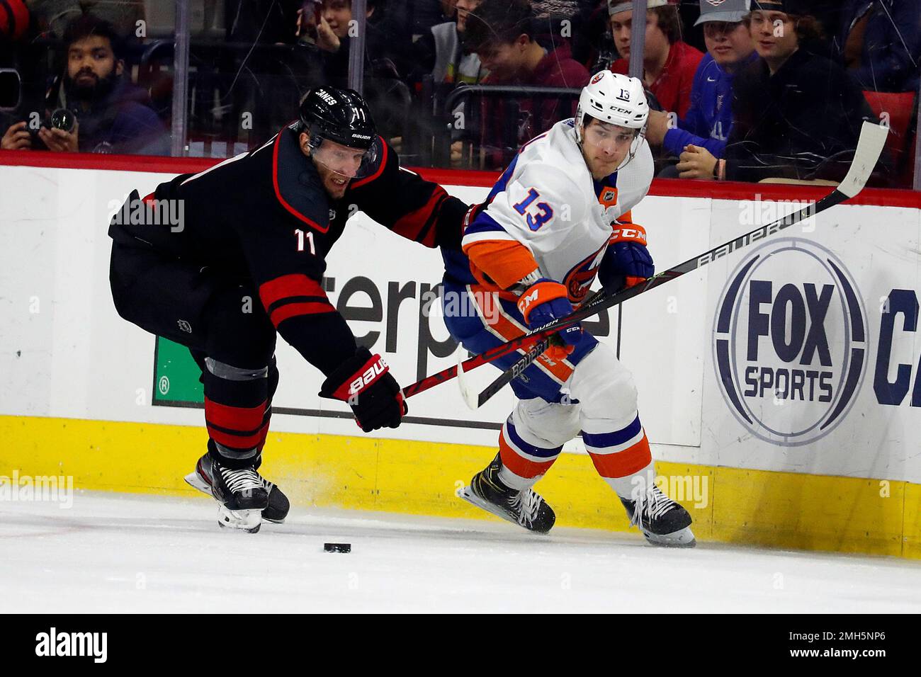 Carolina Hurricanes' Jordan Staal (11) battles with New York Islanders ...