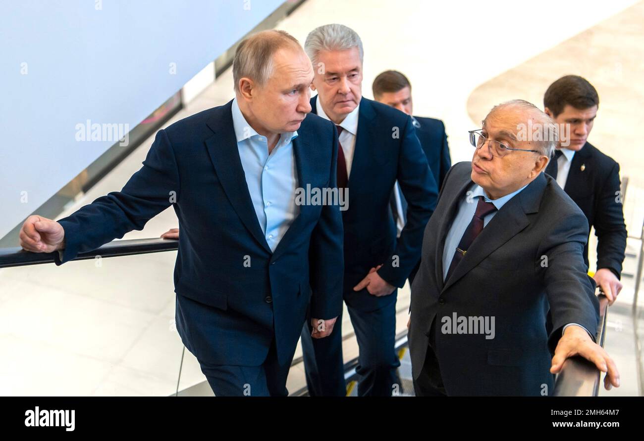 Moscow, Russia. 25th Jan, 2023. Russian President Vladimir Putin, left, rides an escalator during a tour of the Lomonosov cluster with Moscow Mayor Sergei Sobyanin, center, and Moscow State University Rector Viktor Sadovnichy, right, at the Vorobyovy Gory Innovation Science and Technology Centre of Moscow State University, January 25, 2023 in Moscow, Russia. Credit: Maksim Mishin/Kremlin Pool/Alamy Live News Stock Photo