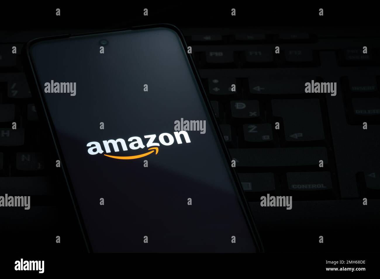 Ljubljana, Slovenia - 21 January 2023: Amazon logo on smartphone screen laying on computer keyboard Stock Photo