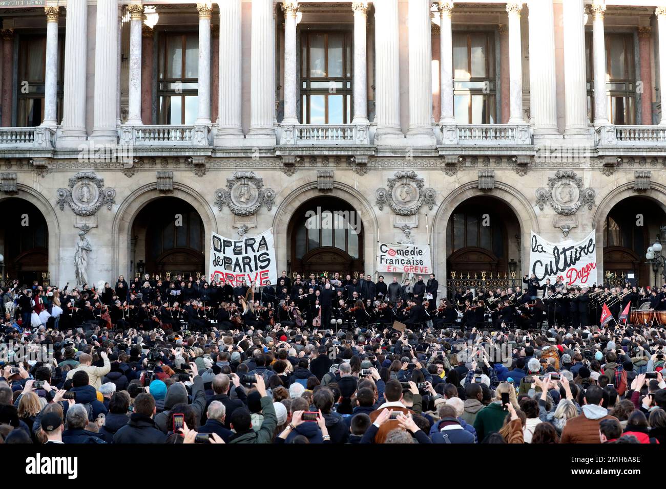 The crowd watch striking musicians performing outside the Paris Ganier ...