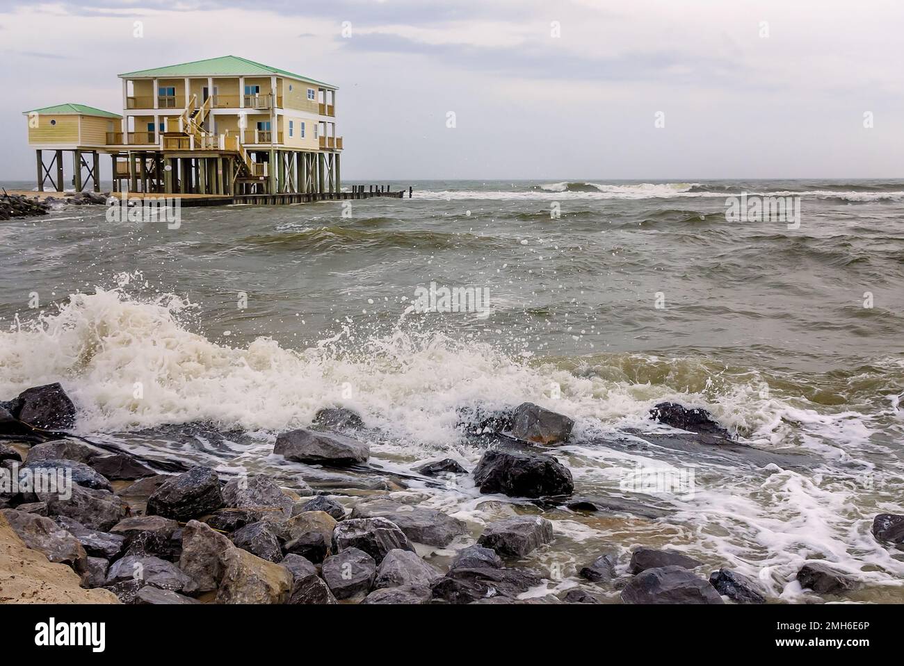 Waves crash near a rental house at Dauphin Island West End Beach, Jan. 3, 2023, in Dauphin Island, Alabama. Stock Photo