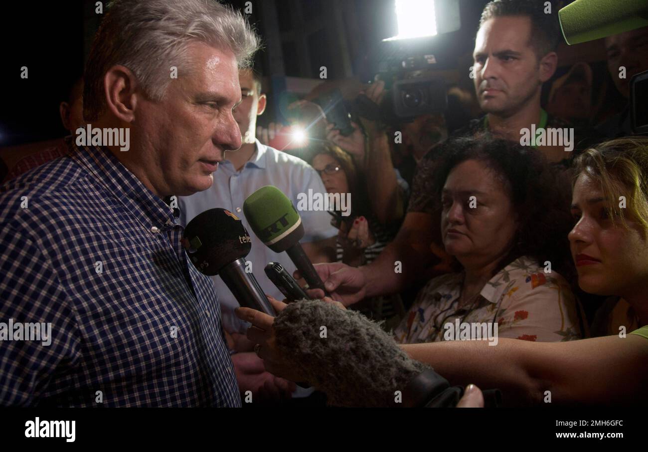 Cuba's President Miguel Diaz-Canel, left, talks to the media after a ...