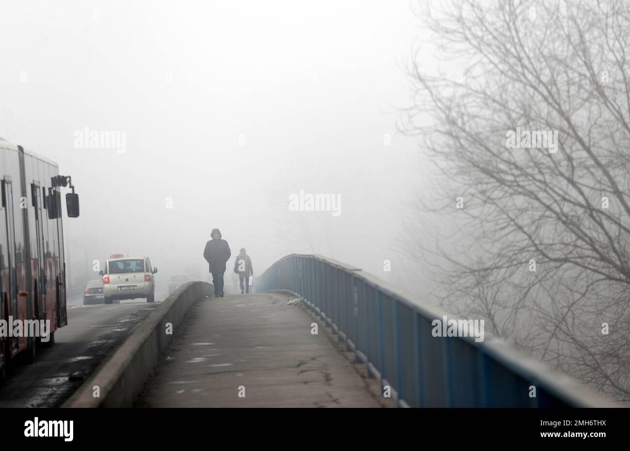 People walk across a bridge in Belgrade, Serbia, Wednesday, Jan. 15