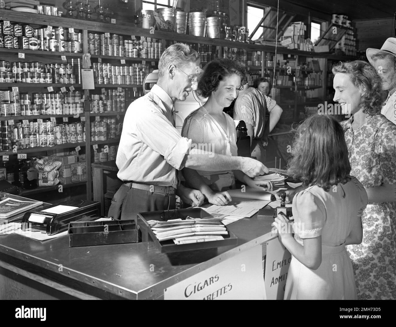 Customer receiving Change from Clerk after shopping at Cooperative Store, Escambia Farms, Florida, USA, John Collier, Jr., U.S. Office of War Information, June 1942 Stock Photo