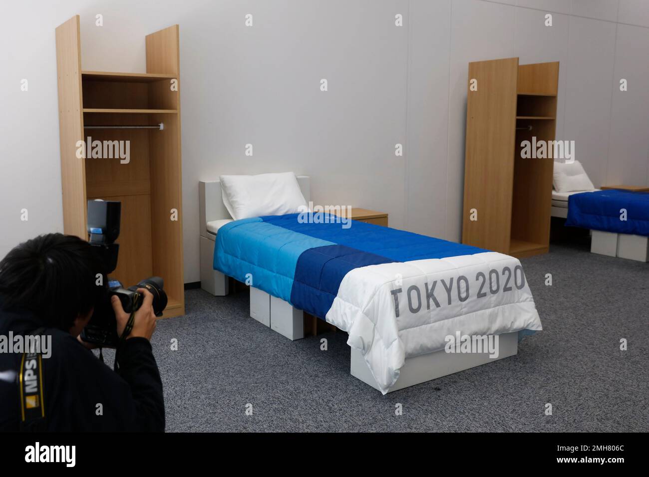 Two sets of bedroom furniture, including cardboard beds, are seen in a