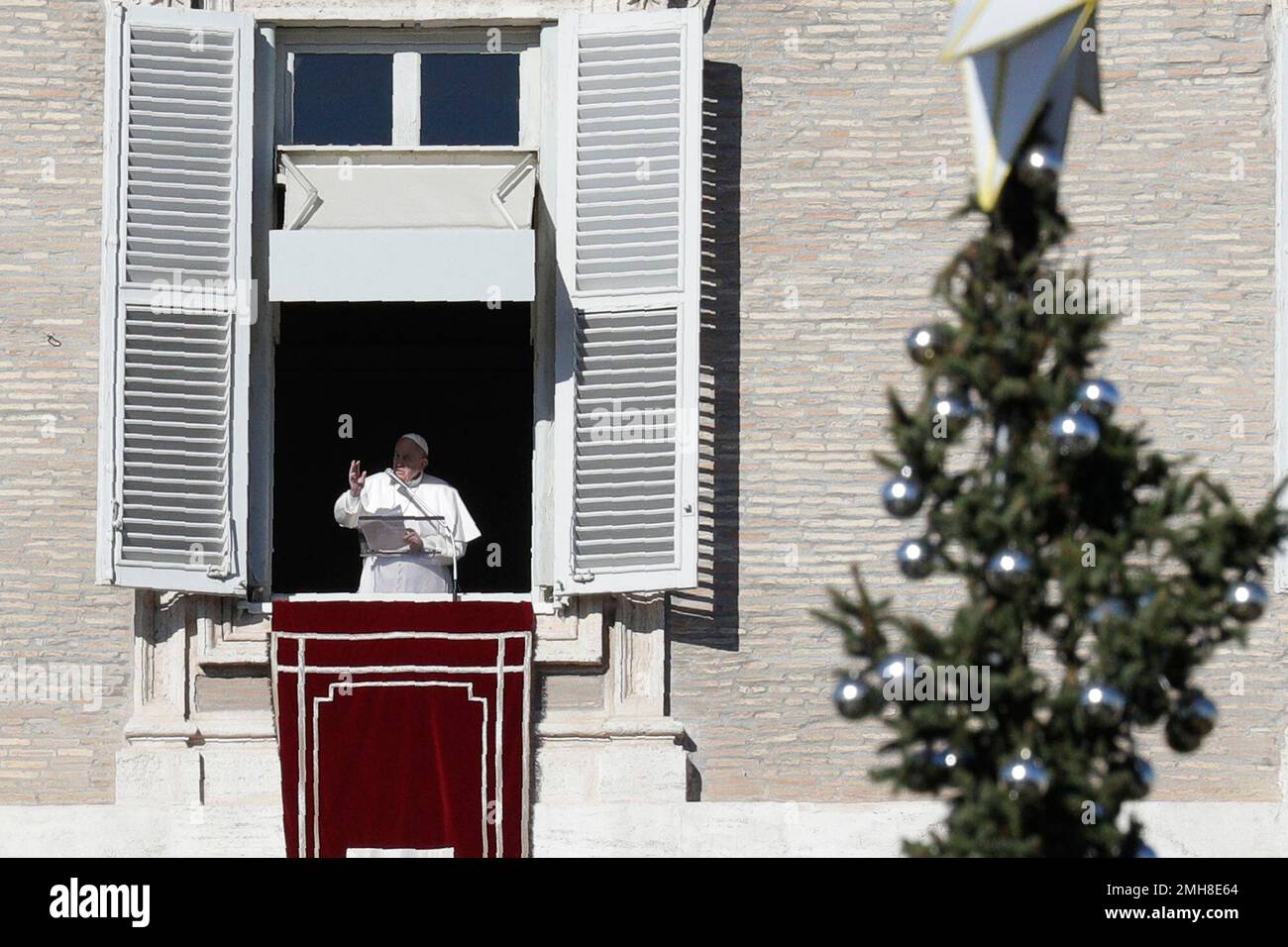 Pope Francis recites the Angelus prayer from his studio's window ...