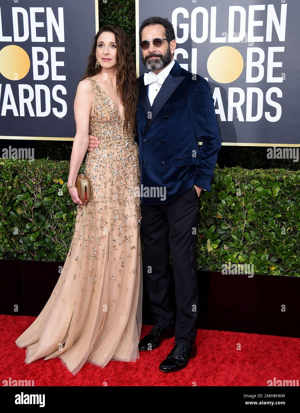 Marin Hinkle, left, and Tony Shalhoub arrive at the 77th annual Golden
