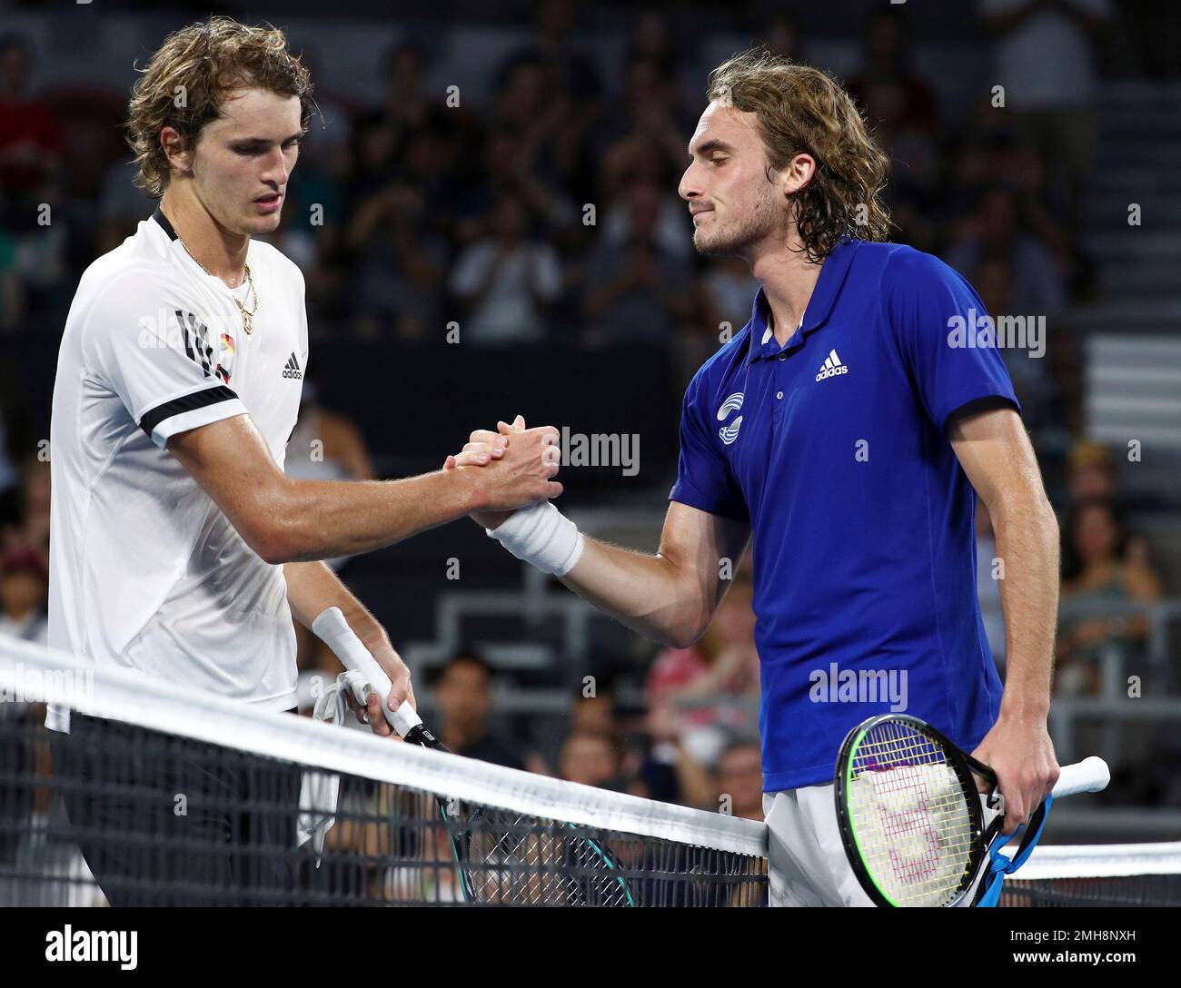 Stefanos Tsitsipas of Greece, right, shakes hands with Alexander Zverev of Germany, left, after winning their match, at the ATP Cup tennis tournament in Brisbane, Australia, Sunday, Jan