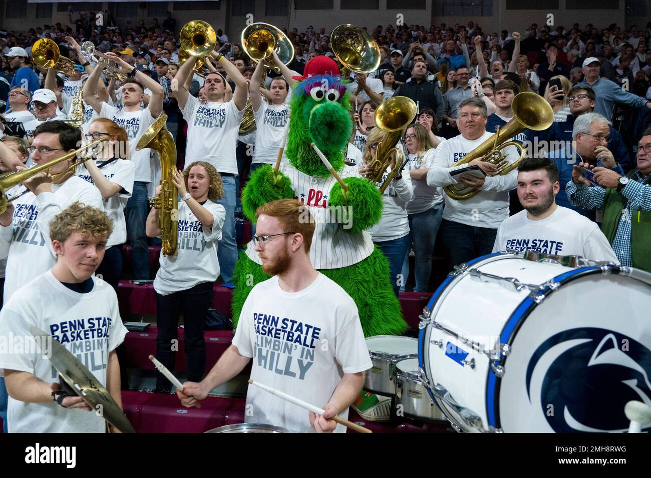 Th Phillie Phanatic, center, interacts with the Penn State band prior