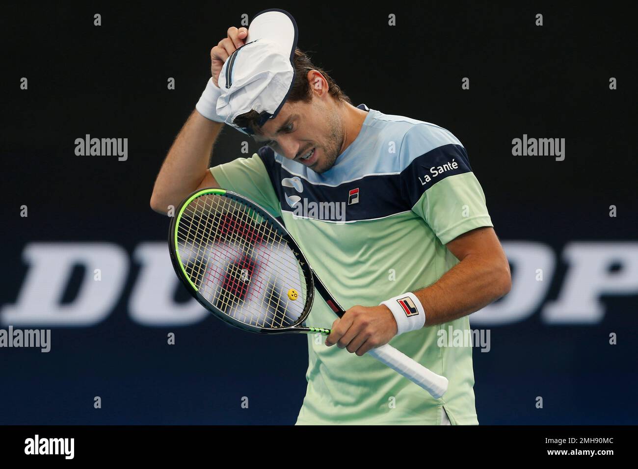 Guido Pella of Argentina adjusts his cap during a play against Kamil  Majchrzak of Poland during their ATP Cup tennis match in Sydney, Saturday,  Jan. 4, 2020. (AP Photo/Steve Christo Stock Photo -