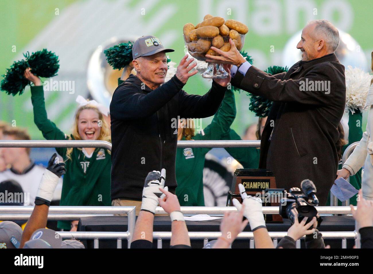 Ohio coach Frank Solichm center, receives the Famous Idaho Potato Bowl