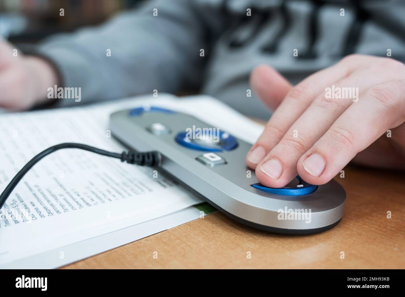 A visually impaired man uses a scanning and reading machine Stock Photo