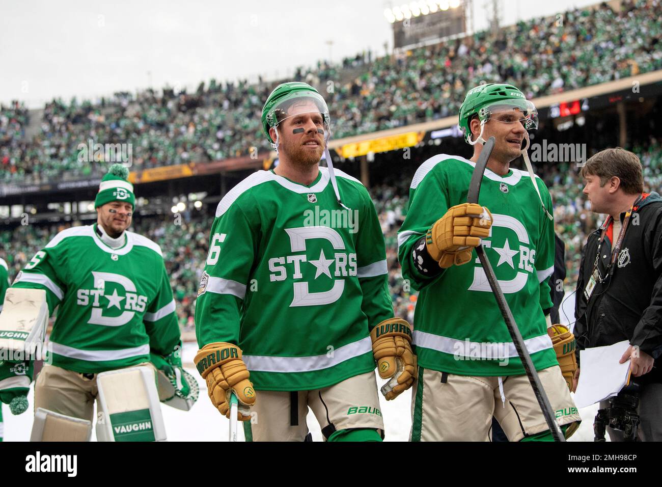 Dallas Stars' Joe Pavelski, center, Andrej Sekera, right, and Anton  Khudobin, left, leave the Cotton Bowl after their 4-2 win over the  Nashville Predators in the NHL Winter Classic hockey game, Wednesday,