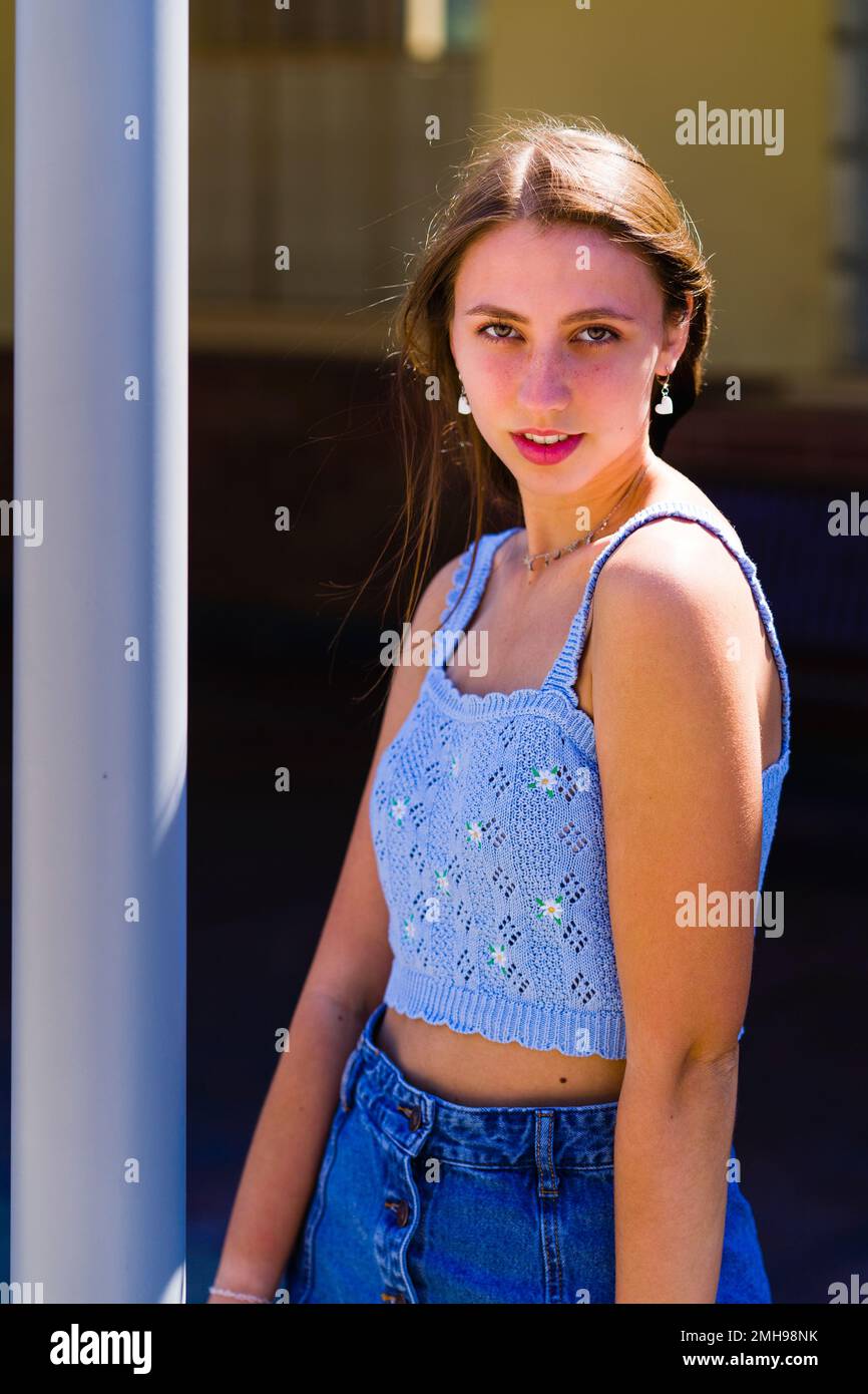 Half Body Portrait of Flirty Looking Teenage Girl Standing with Hair Blowing in the Wind - Summer - Summertime Stock Photo