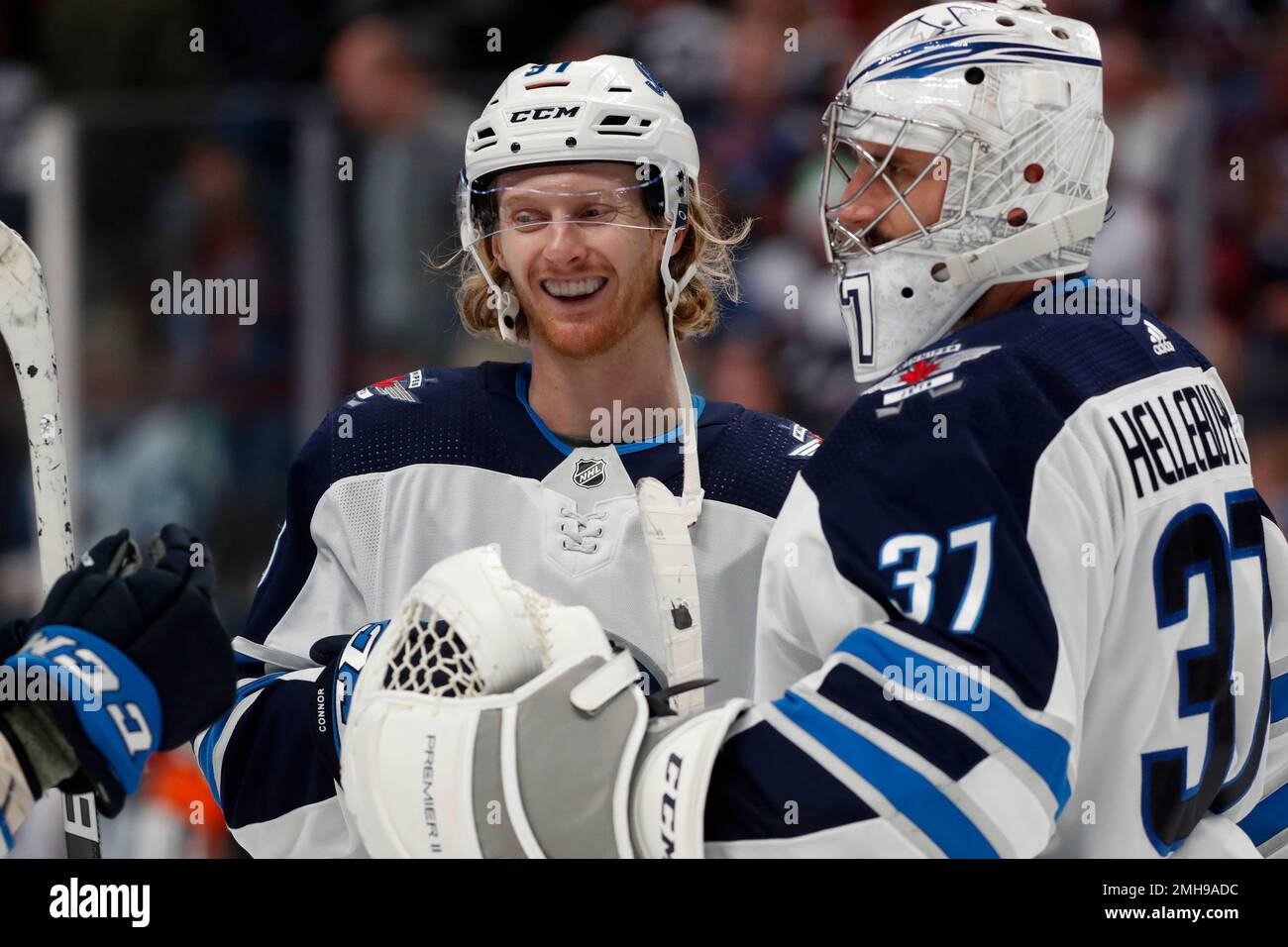 Winnipeg Jets left wing Kyle Connor, left, congratulates goaltender Connor  Hellebuyck at the end of the team's NHL hockey game against the Colorado  Avalanche on Tuesday, Dec. 31, 2019, in Denver. Winnipeg