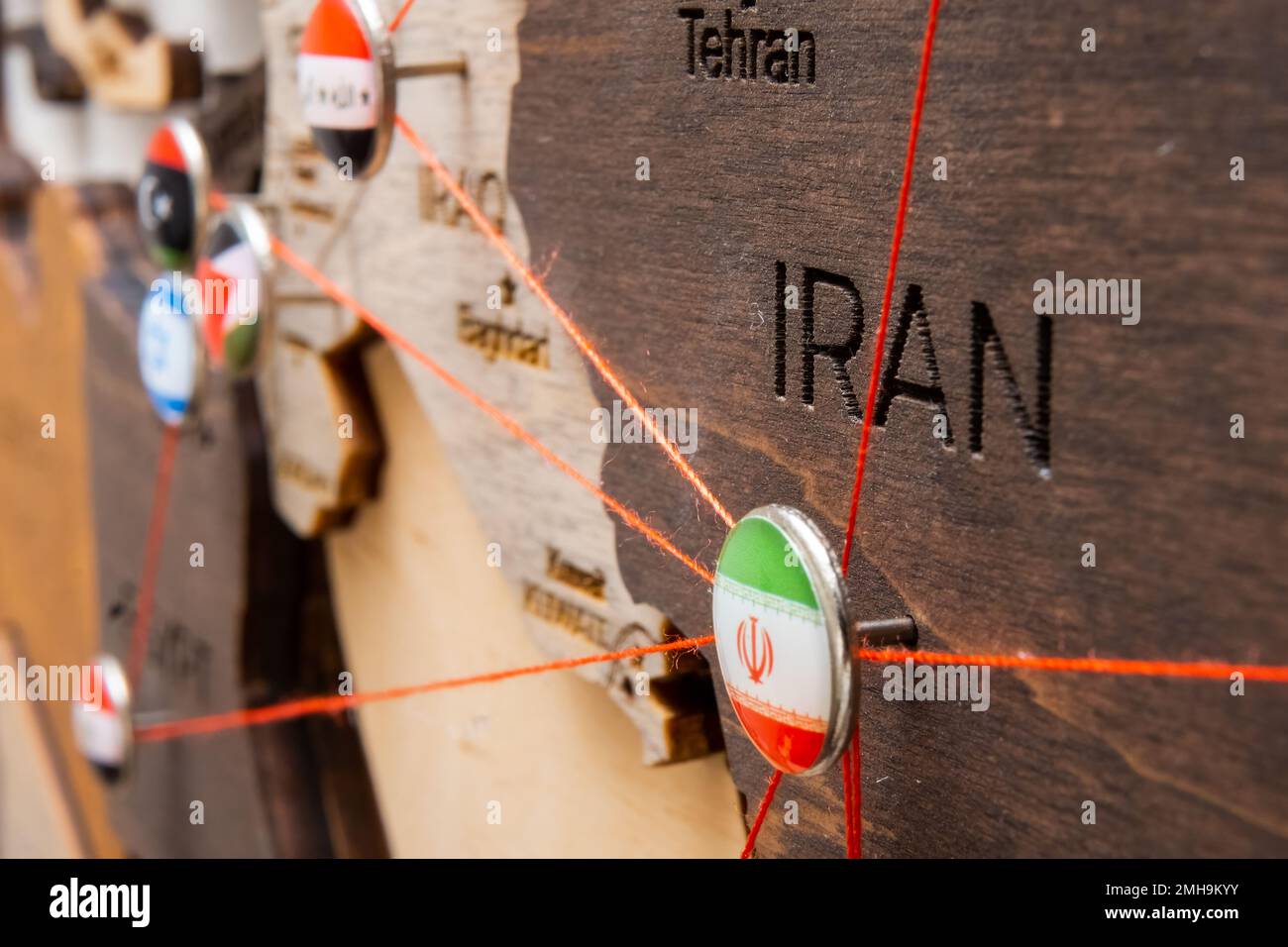 Iran flag on the pushpin with red thread showed the paths of movement ...