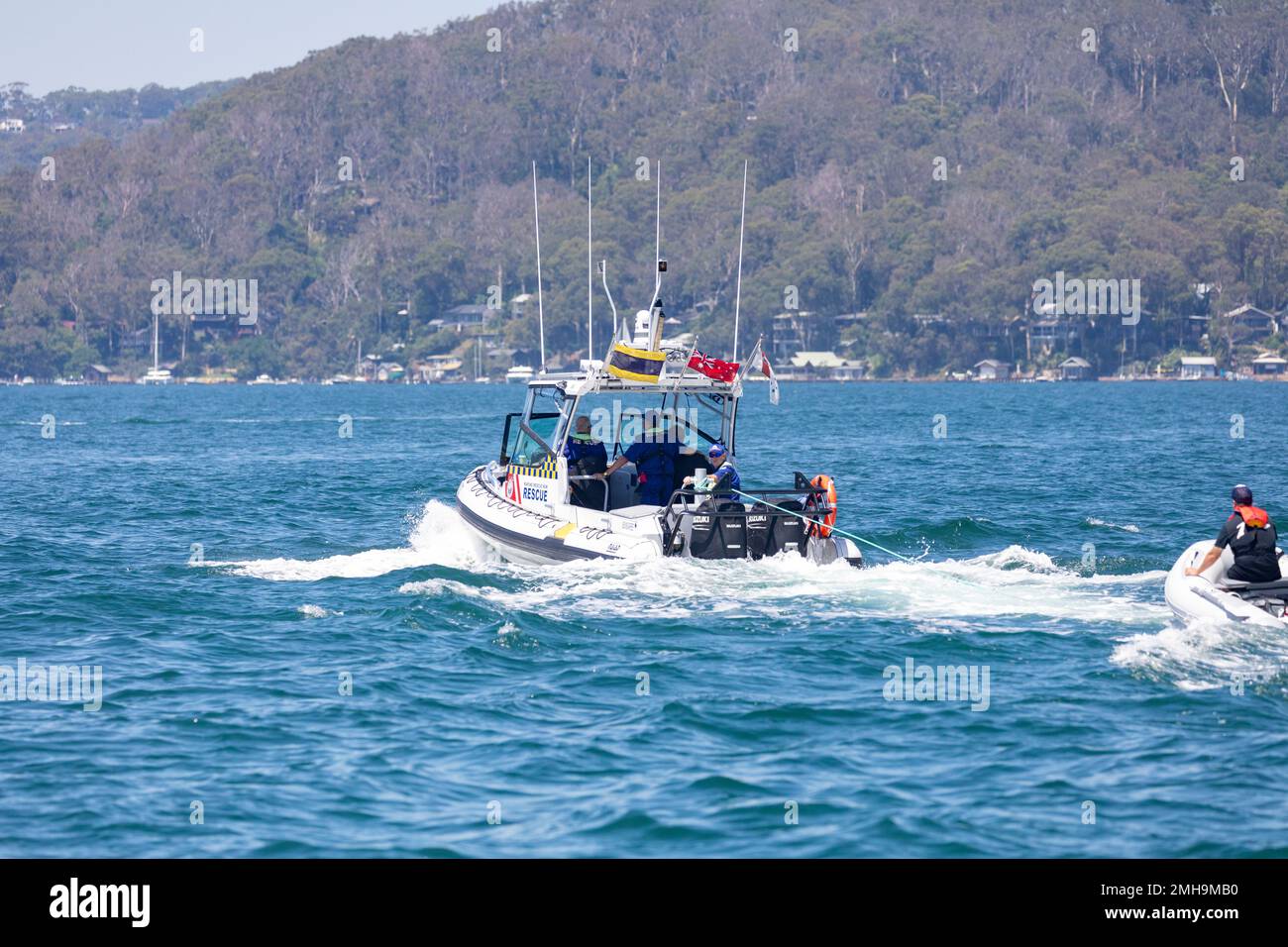 Marine Rescue NSW volunteer staff, rescue a small dinghy boat on ...