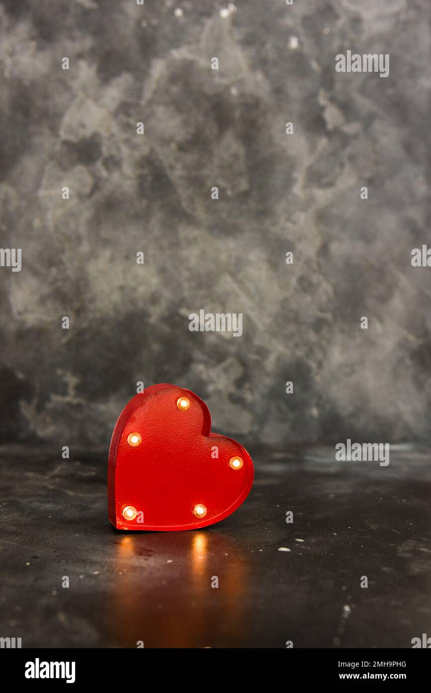Red lighted heart on a black bacground. Copy space Stock Photo