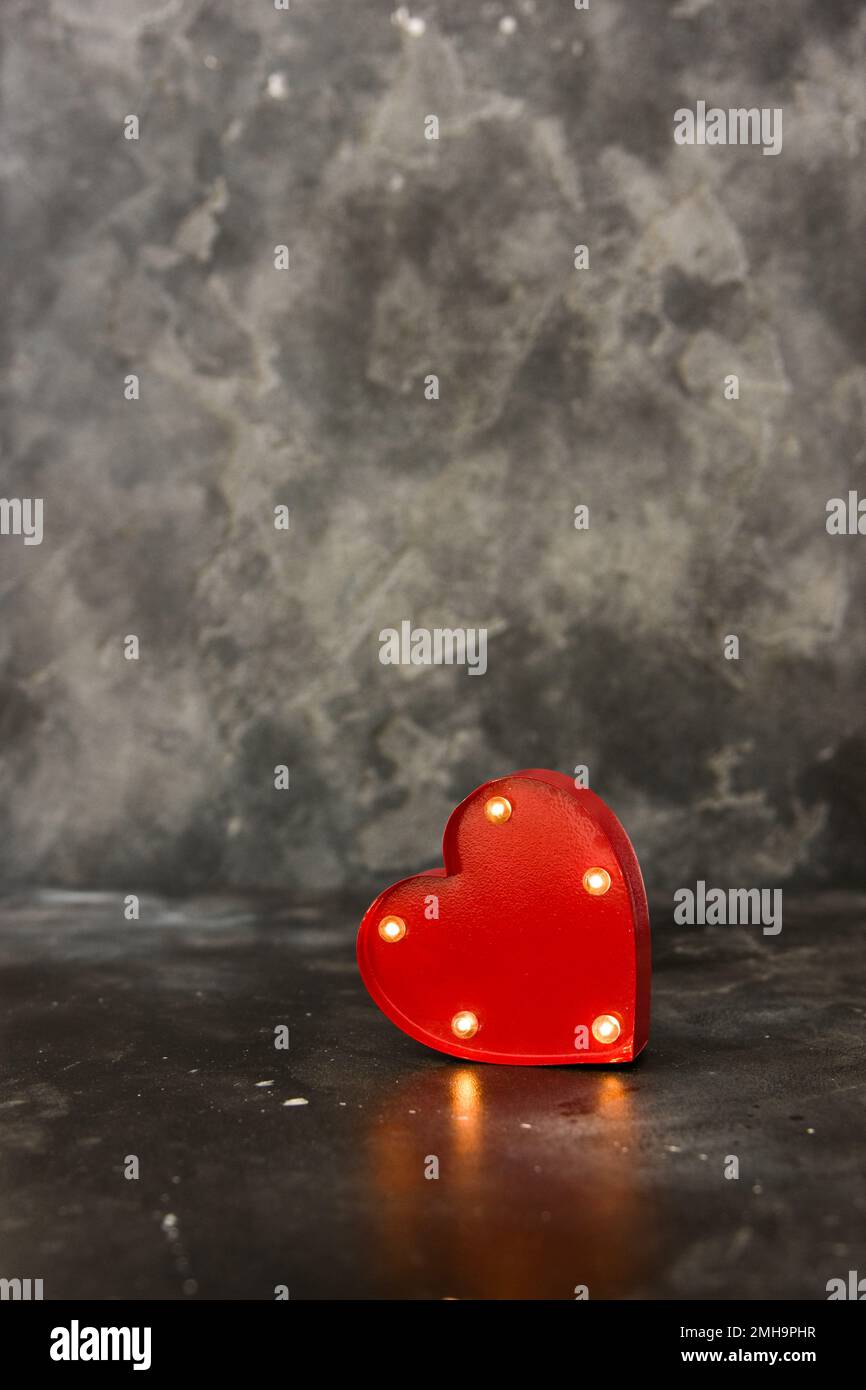 Red lighted heart on a black bacground. Copy space Stock Photo
