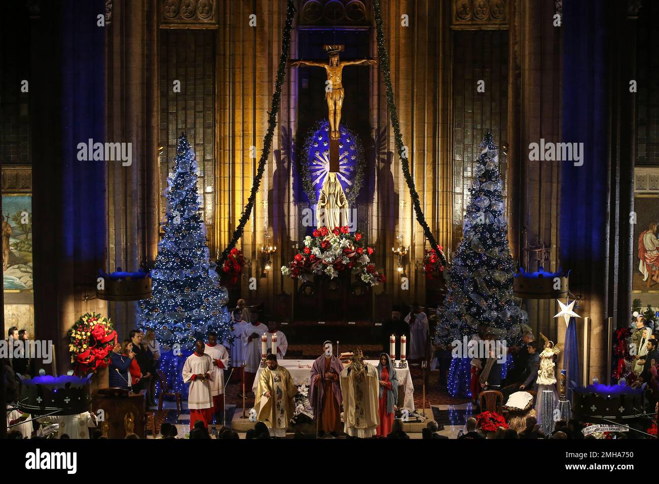 People participate in a Catholic Christmas Eve mass in St. Antoine