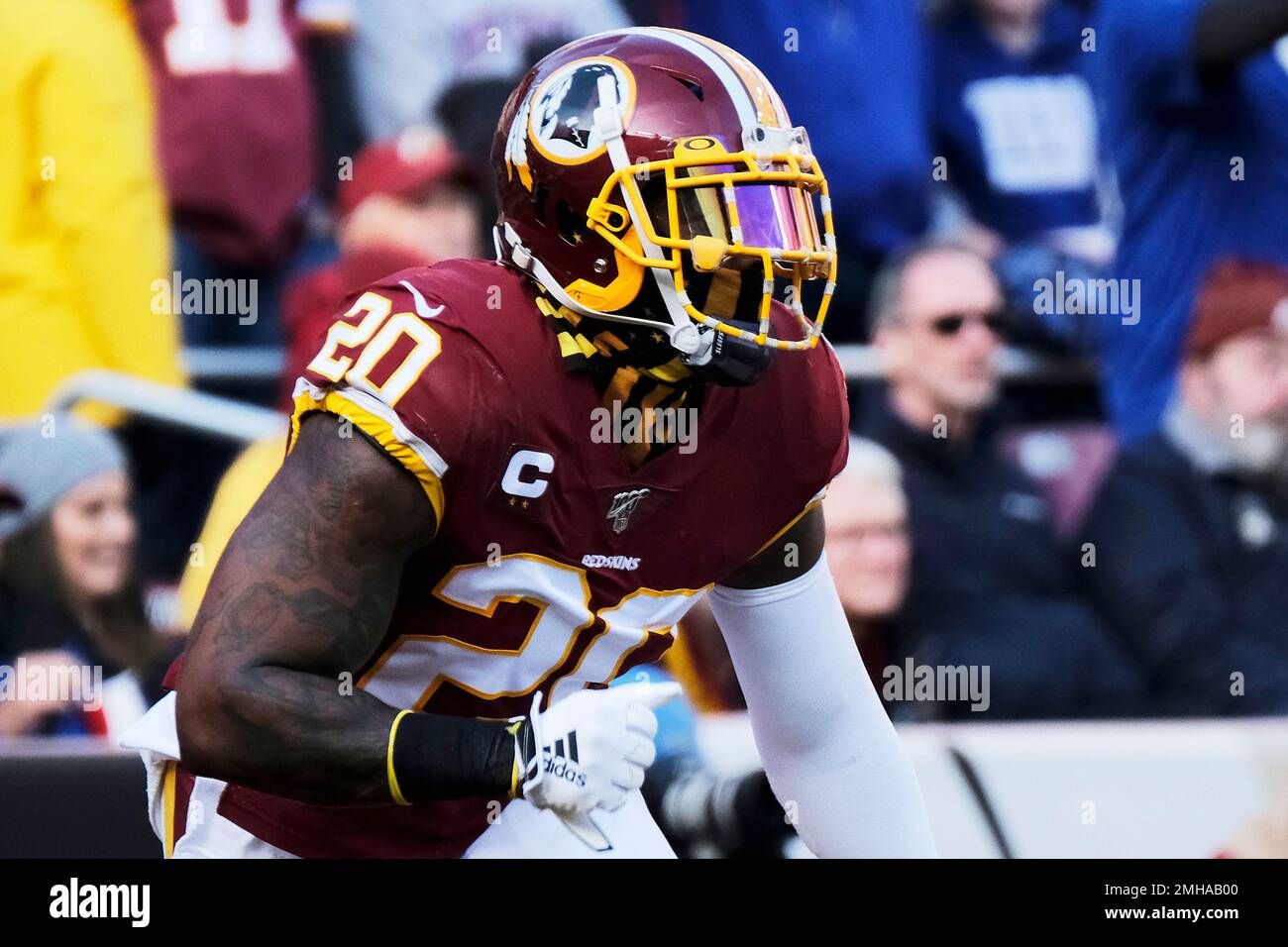 Washington Redskins strong safety Landon Collins (20) and New York Giants  running back Saquon Barkley (26) trade jerseys following an NFL football  game between the New York Giants and the Washington Redskins