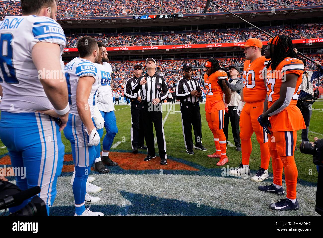 Detroit Lions and Denver Broncos players meet for the coin toss at