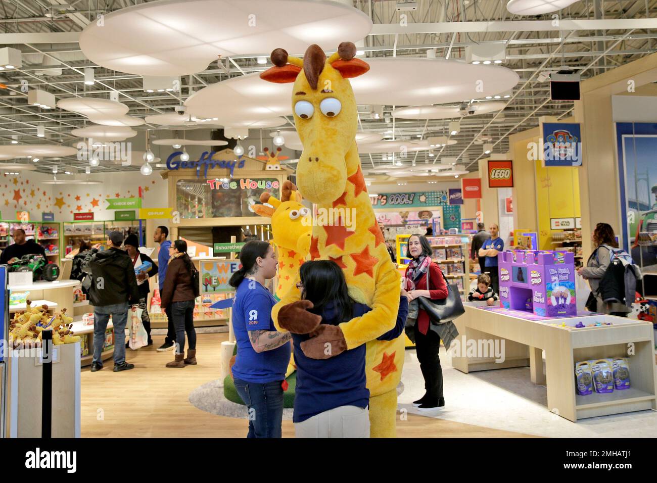 In this Dec. 9, 2019, photo a girl hugs the Toys R Us mascot, Geoffrey ...