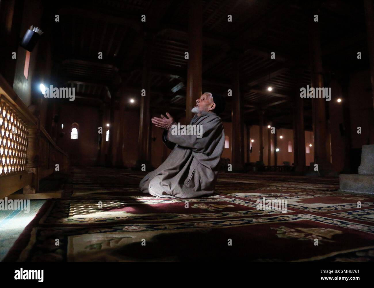 An elderly Kashmiri Muslim man prays inside Jamia Masjid in Srinagar ...