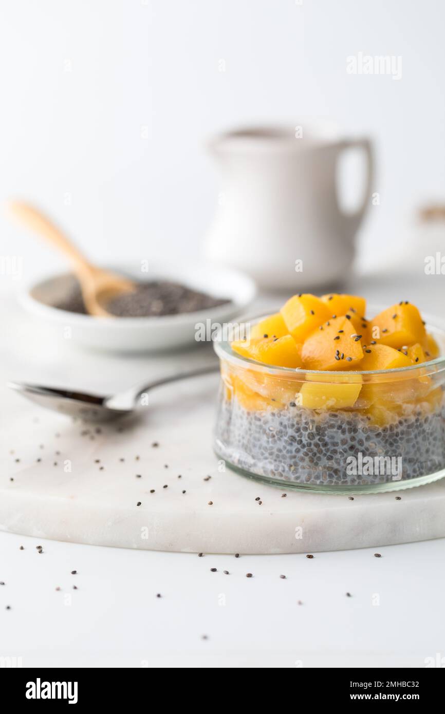 Close up of a chia pudding topped with chopped mango, ready for eating. Stock Photo