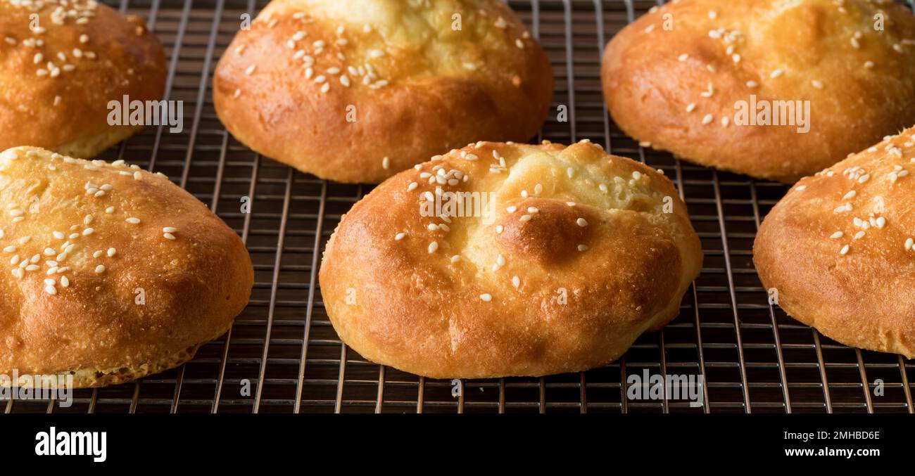 Fresh ketogenic hamburger buns topped with sesame seeds, fresh out of the oven. Stock Photo