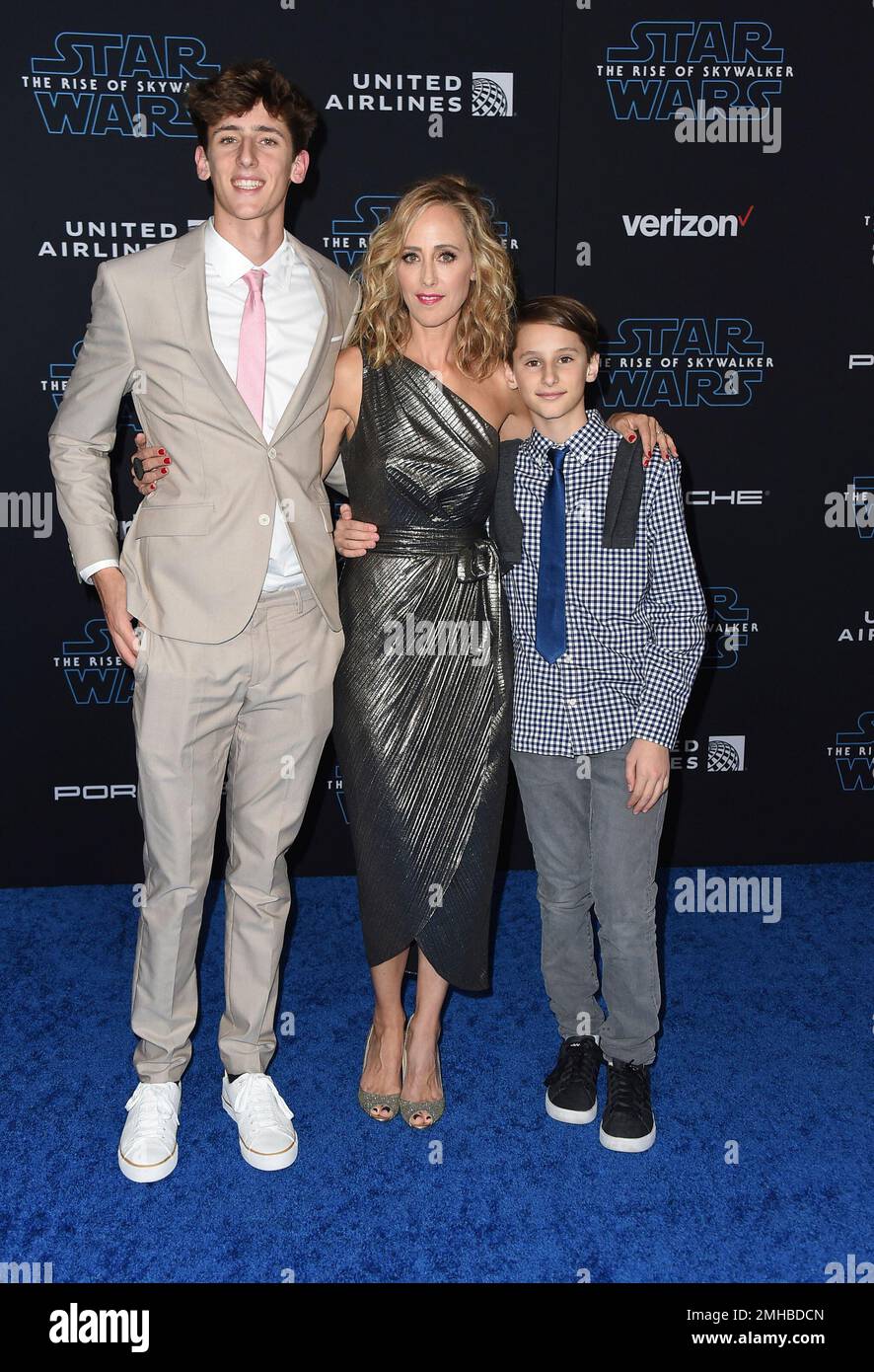 Luke Boyer, from left, Kim Raver and Leo Boyer arrive at the world