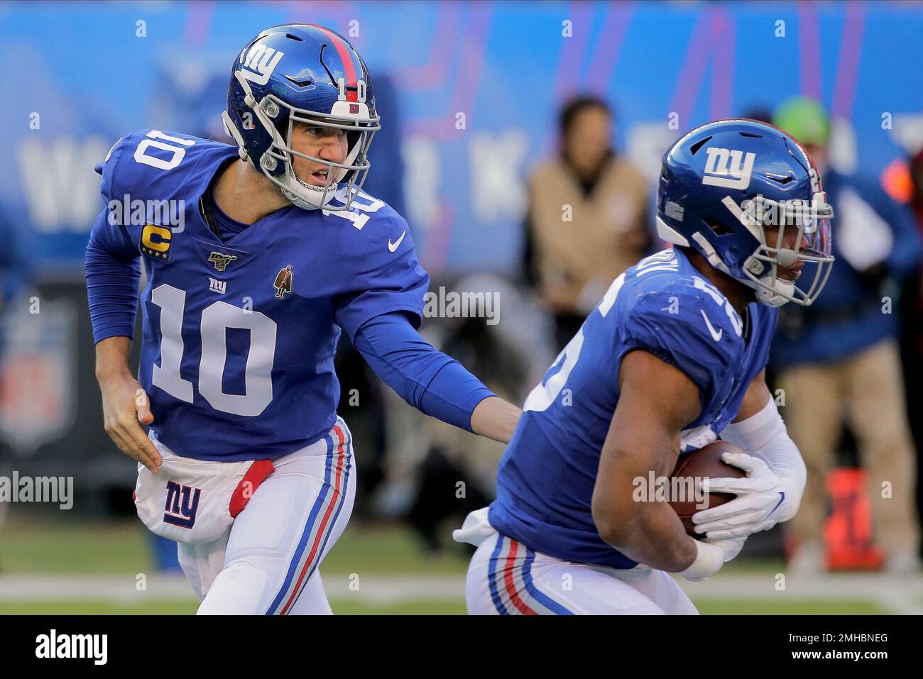 New York Giants Eli Manning stands with Saquon Barkley on the