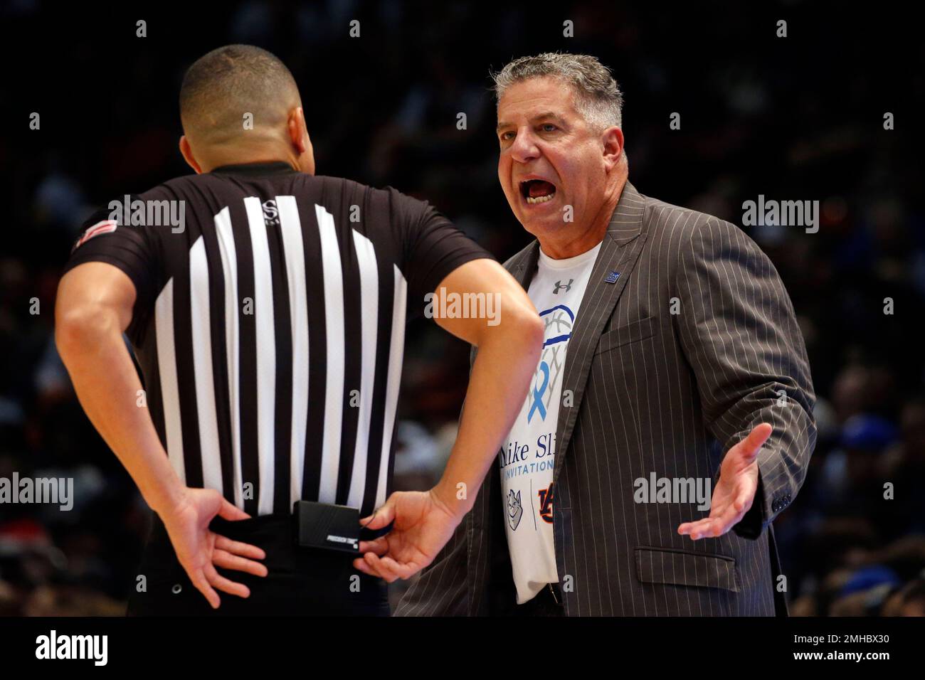 Auburn head coach Bruce Pearl, right, talks with a referee about a call  during the second half of an NCAA college basketball game against Saint  Louis, Saturday, Dec. 14, 2019, in Birmingham,