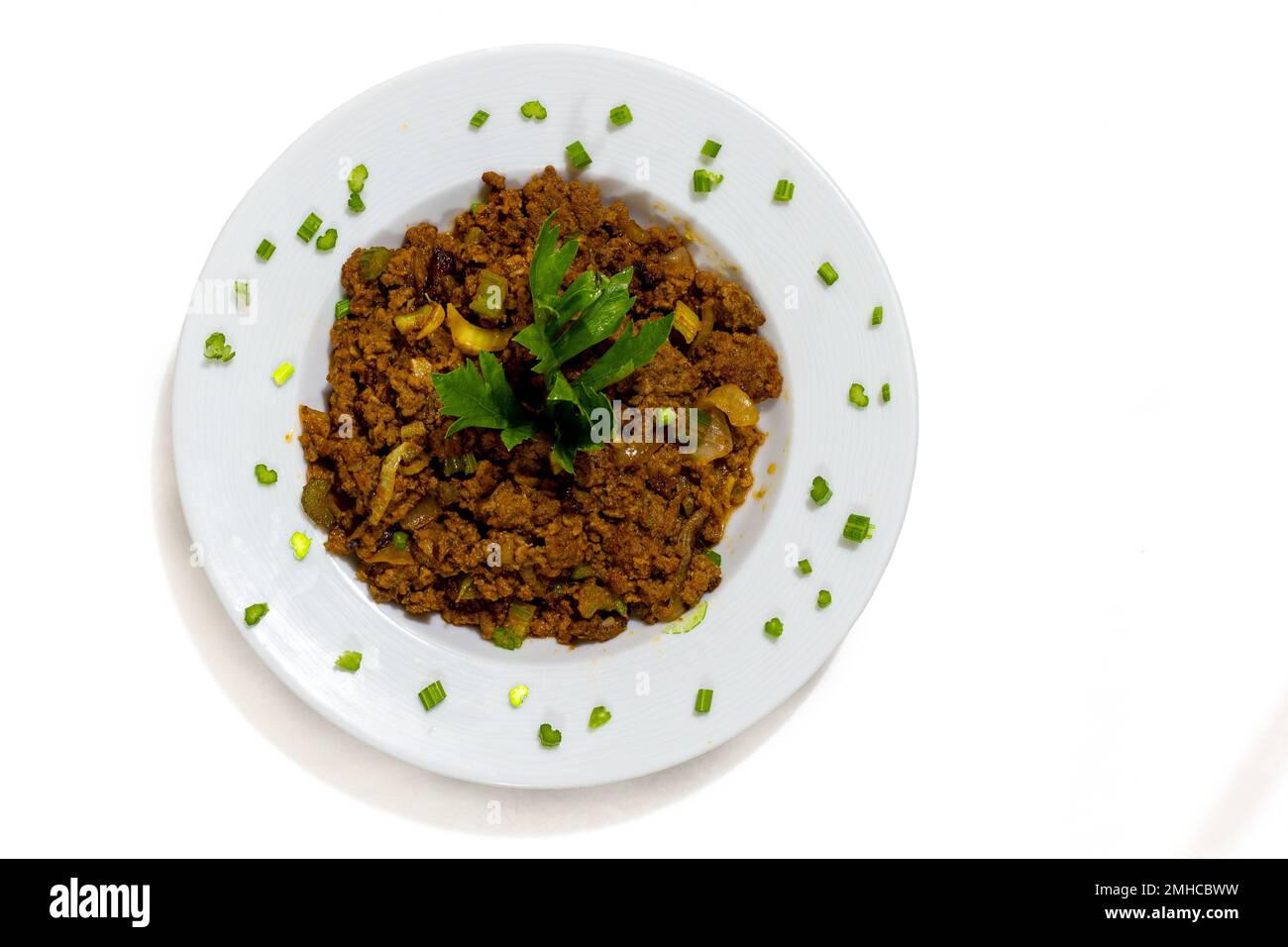 beef hash on a plate on a white background Stock Photo - Alamy