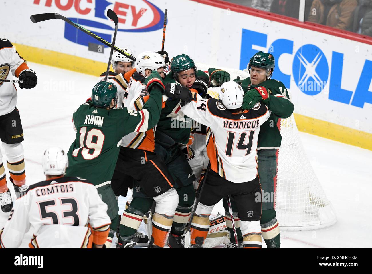 Minnesota Wild's Jordan Greenway, center, is surrounded by Wild