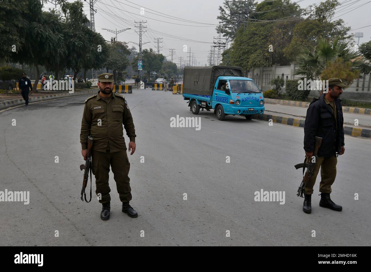 Police officers take positions outside the Pindi Cricket stadium to