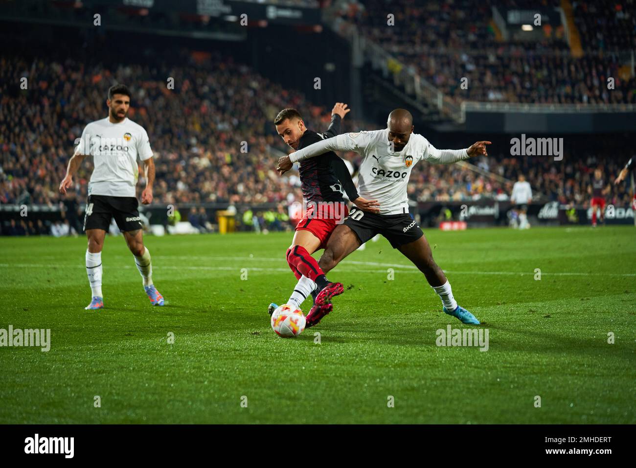 Valencia, Spain. 26th Jan, 2023. Alejandro Berenguer Remiro of Atheltic Club (C) and Dimitri Foulquier of Valencia CF (R) seen in action during the Quarterfinals of the Copa del Rey between Valencia CF and Athletic Club at Mestalla Stadium.Final score; Valencia CF 1:3 Athletic Club (Photo by Vicente Vidal Fernandez/SOPA Images/Sipa USA) Credit: Sipa USA/Alamy Live News Stock Photo